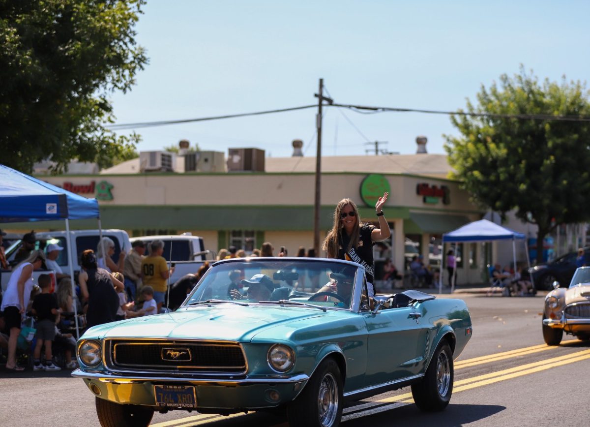 The Grand Marshall leads the Homecoming Parade.